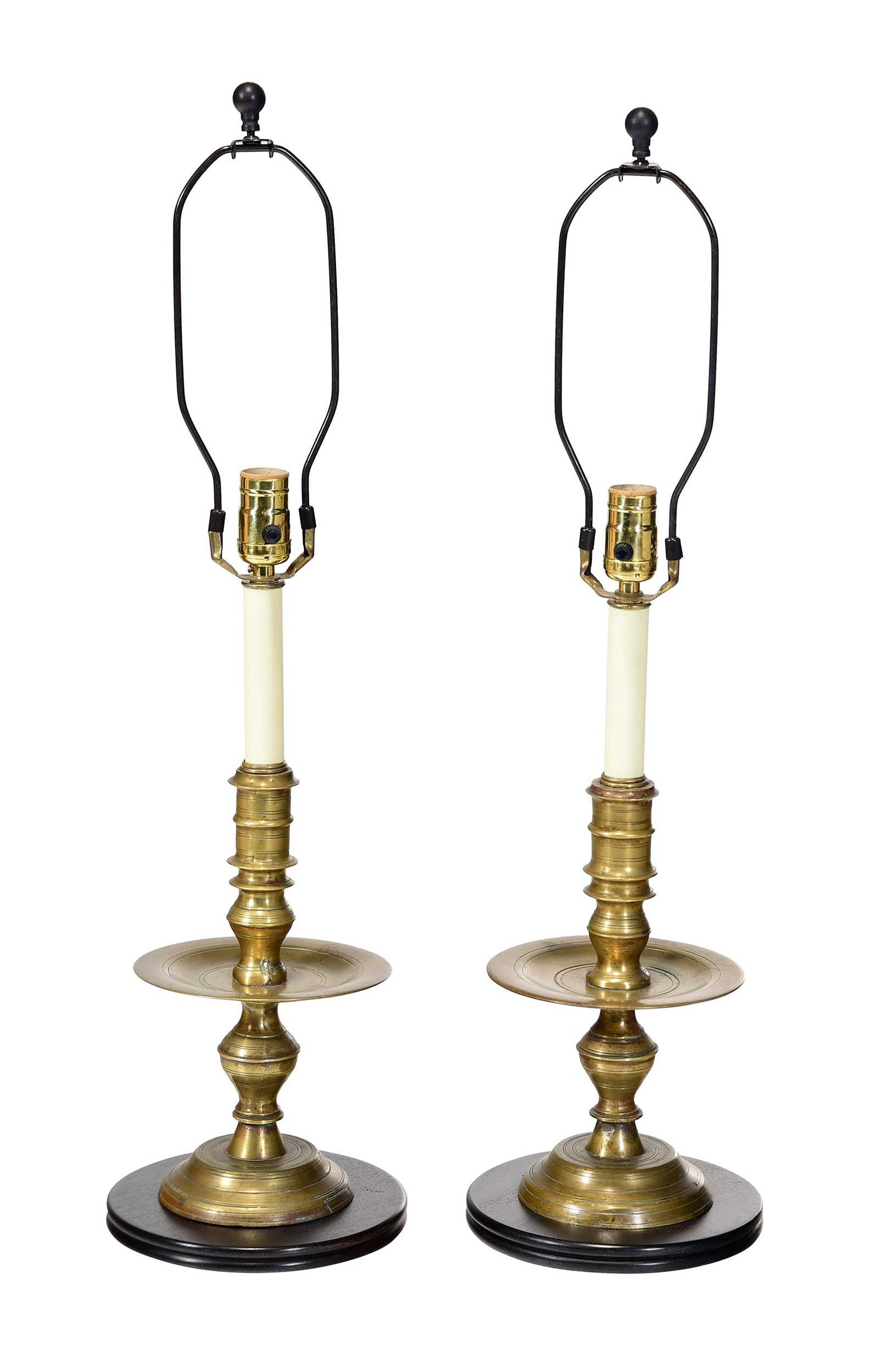 Pair of Continental Brass Candlesticks Converted to Lamps: possibly Dutch, possibly 18th century, on wood bases, candlesticks 11 x 6-1/2 x 6-1/2, overall (to finial) 29-1/2 in. Provenance: Property of a South Carolina Collector