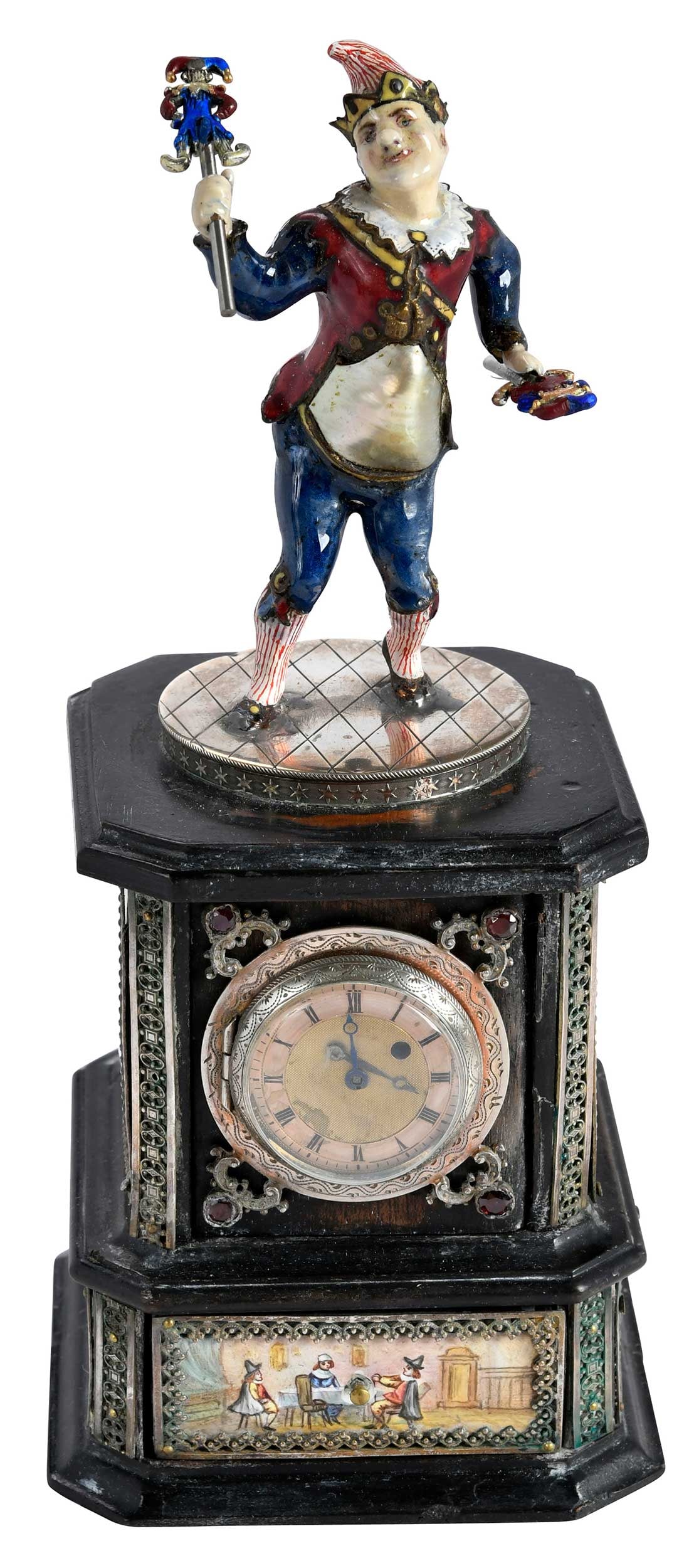 Viennese Silver, Enamel, and Freshwater Pearl Jester Clock: Austria, late 19th century, jester holding marotte, freshwater pearl accent, on a square base, one drawer with circular clock and paneled enameled sides, 8 in. Provenance: Collection of Steve Stewart,