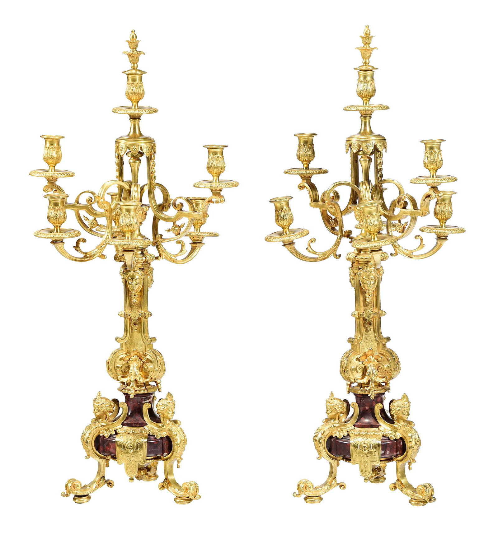 Large Pair French Gilt Bronze Six Light Candelabra: 20th century, segmented shaft with mask form appliques issuing six scrolled arms with candle cups, scrolled figural and trifid bases, each 34 x 16 x 14 in. Provenance: Private Charlotte Collection
