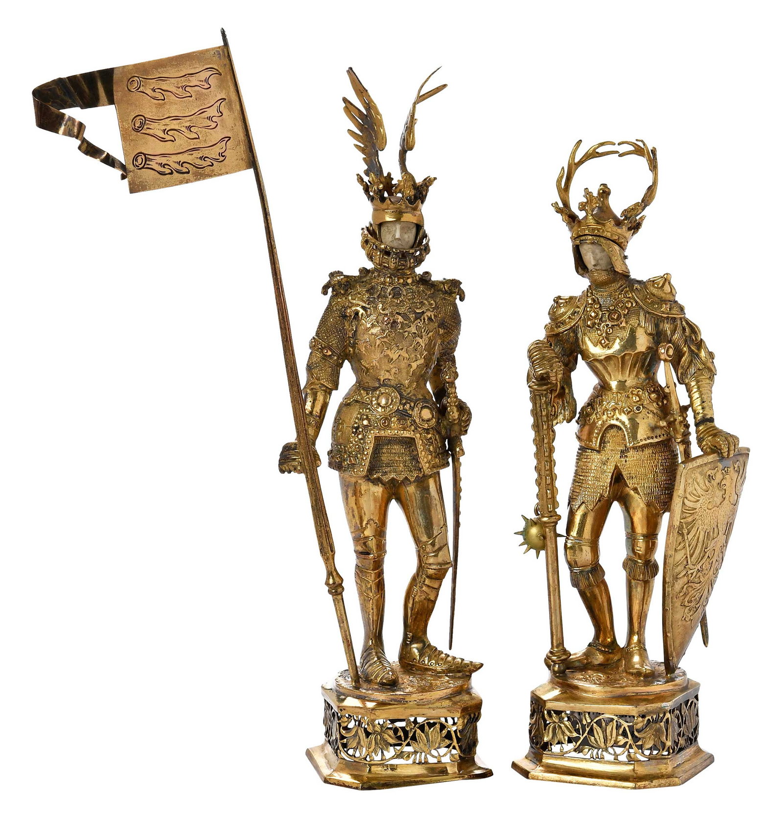 Pair of German Gilt Silver Knights: Hanau, late 19th/early 20th century, one with winged helmet and holding flag, one with antler helmet holding mace and shield, both with ivory face and matching bases, one with partial marks for B.