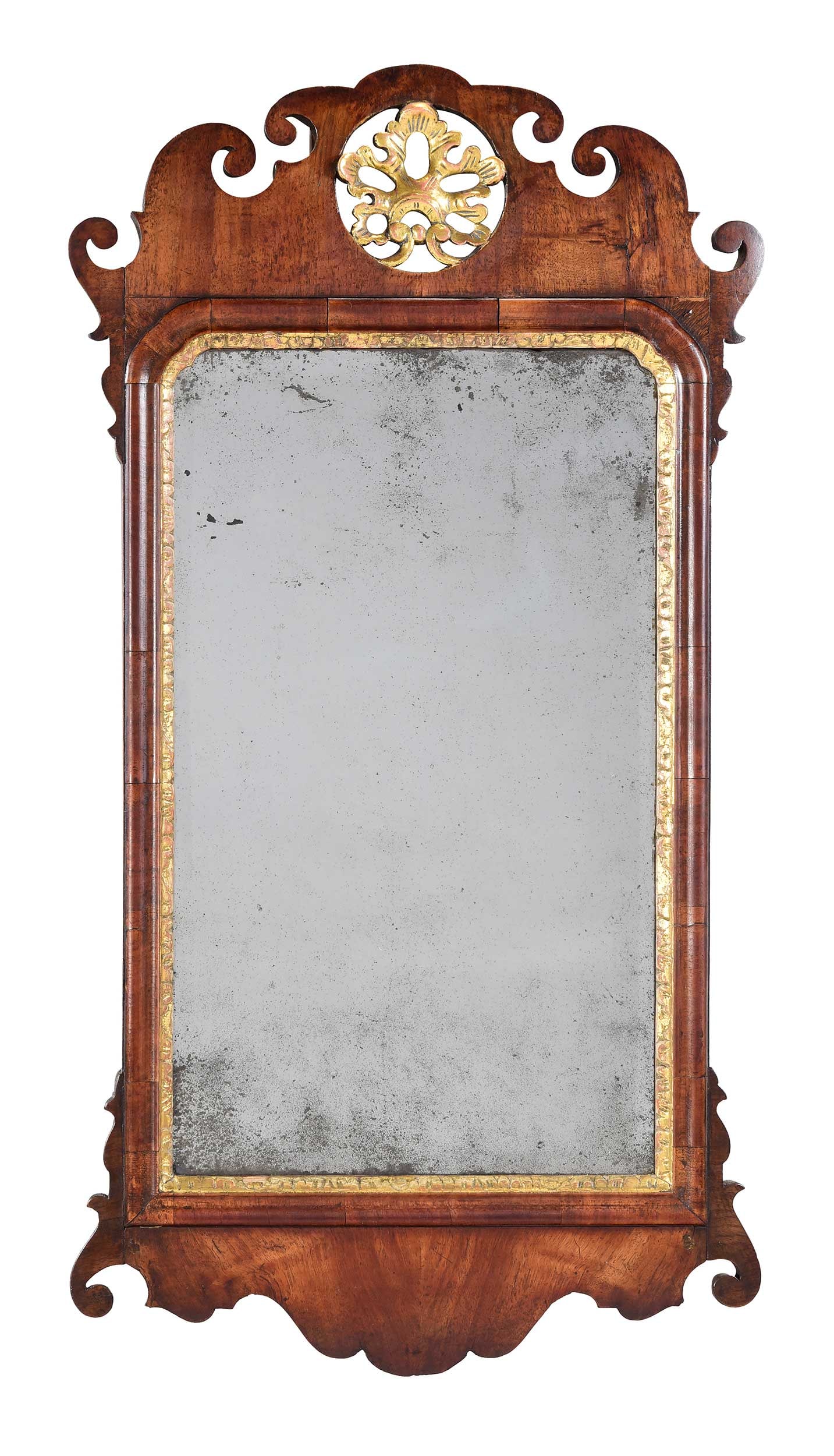 American Federal Carved and Pierced Parcel Gilt Mahogany Mirror: late 18th century, early and possibly original mirror plate, crest with pierced acanthus roundel, scrolled carvings to frame, 34-1/4 x 18 x 1-1/4 in. Provenance: Private Florida Collection