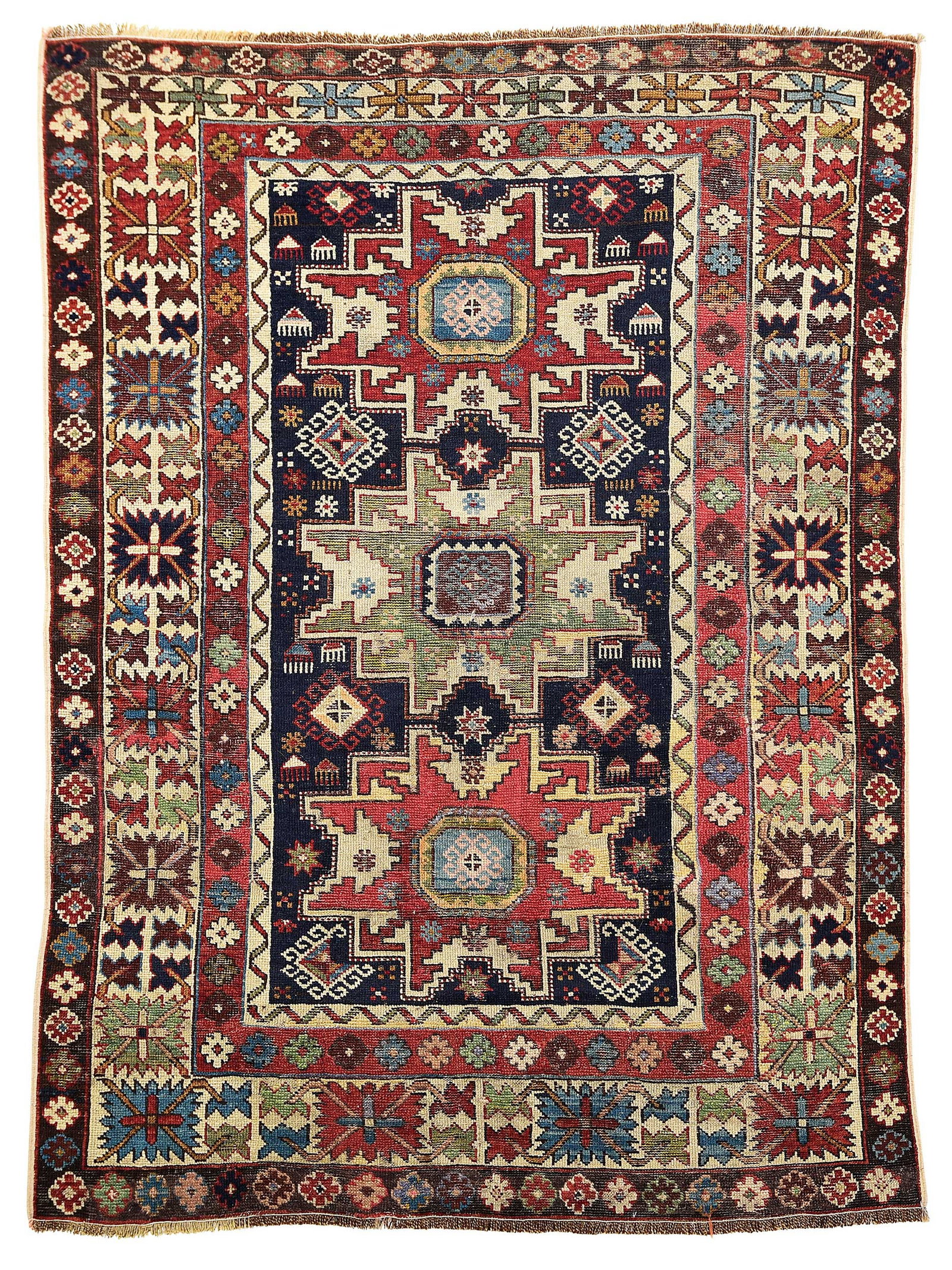 Small Kazak Rug: first quarter 20th century, three medallions on blue field, geometric designs throughout, 4 ft. 3 in. x 3 ft. 2 in. Provenance: Private Collection, Florida