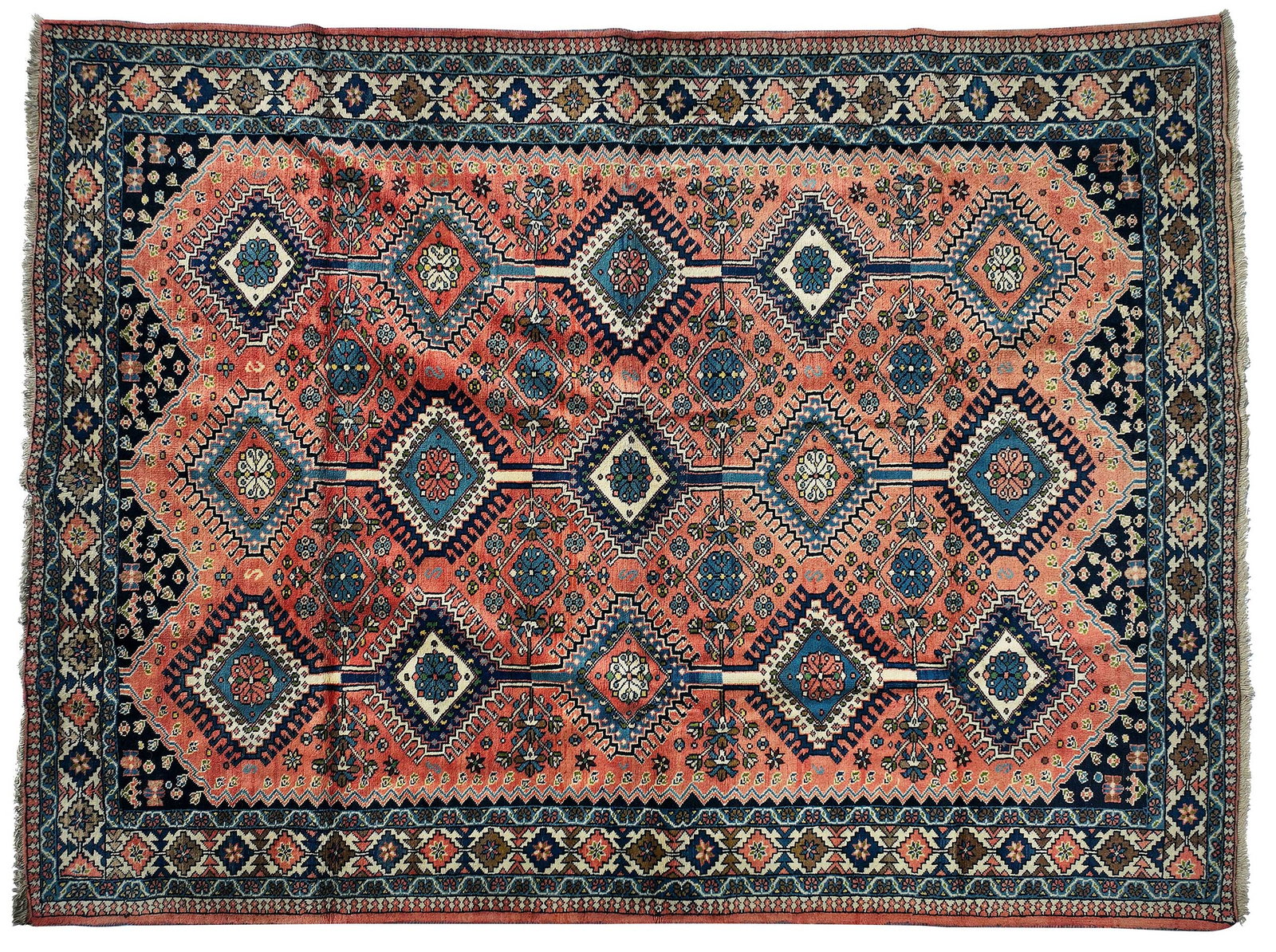 Yalameh Rug: second half 20th century, three rows of connected hooked medallions on red ground, "MADE IN IRAN" label to corner, 9 ft. 3 in. x 6 ft. 10 in. Provenance: Private Collection, Asheville, North Carolina