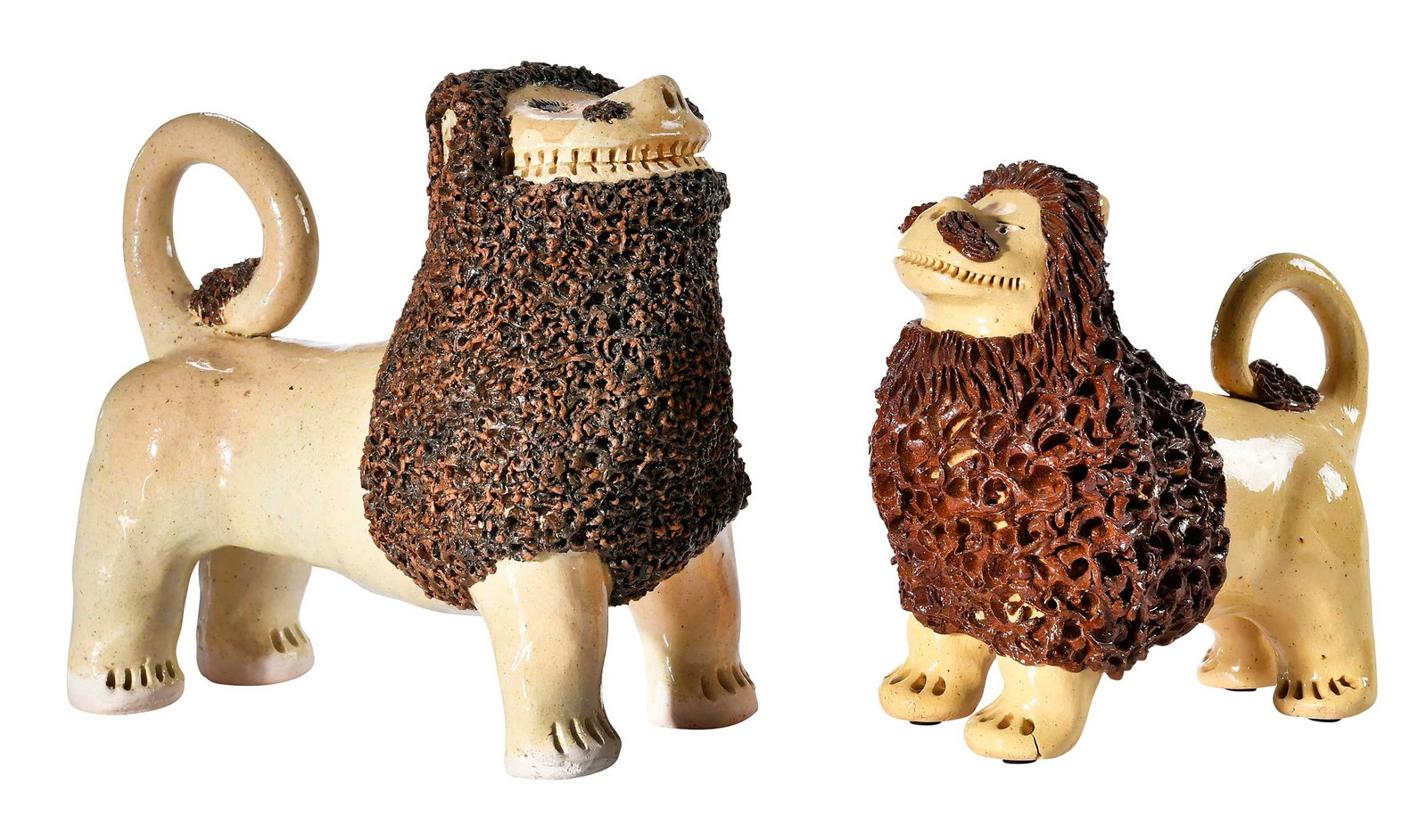 Two Billy Ray Hussey North Carolina Folk Pottery Lions: Bennett, North Carolina, contemporary, yellow and brown lions in the style of John Bell, yellow glazed bodies, brown glazed manes, tails, and facial hair, larger lion with cobalt eyes inscribed "BH"