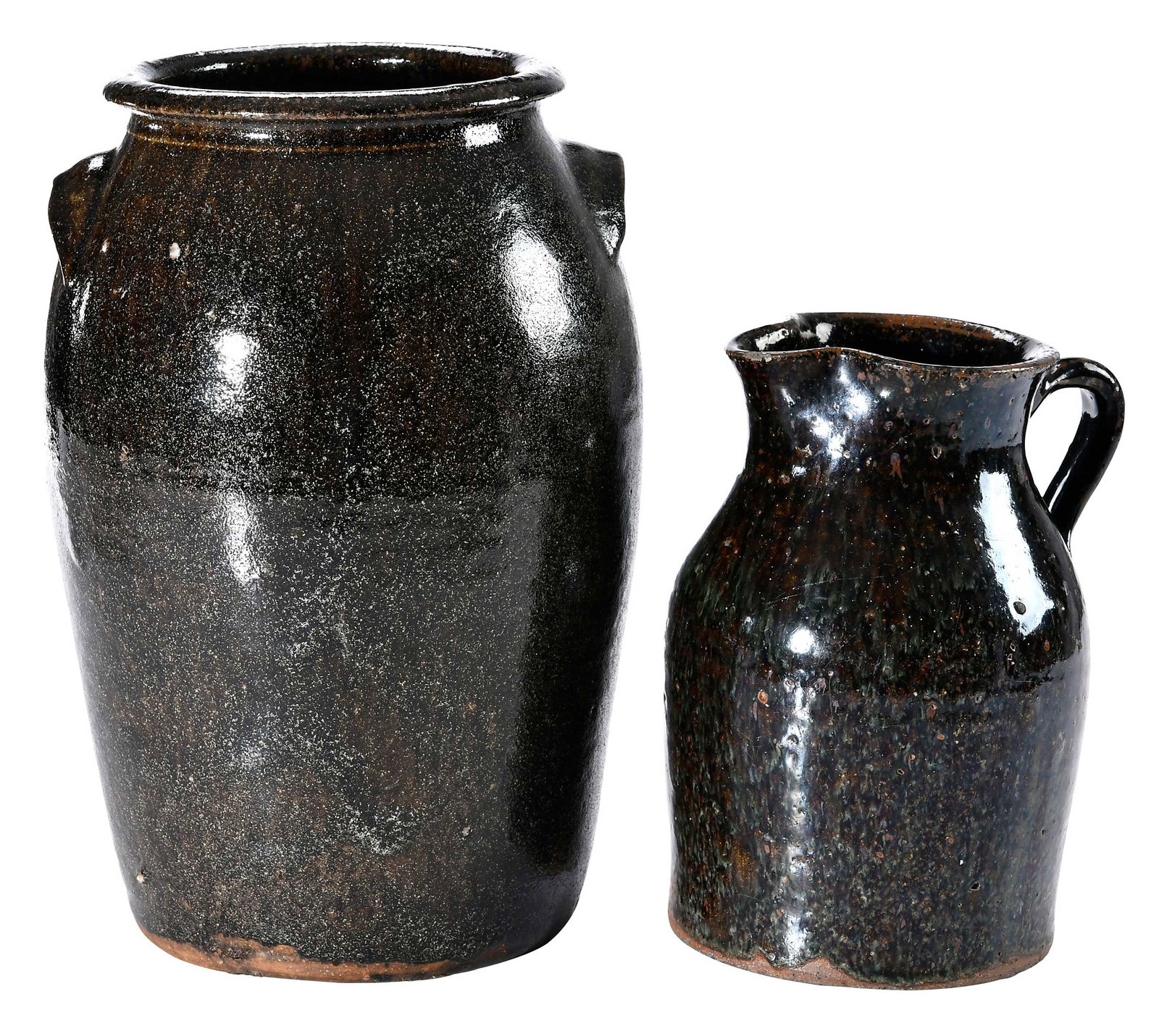 Two Pieces of Buncombe County North Carolina Attributed Stoneware: circa late 19th, early 20th century, pitcher with yellowish brown underglaze, creamy bluish green glaze runs and highlights, angled shoulder, applied strap handle, pulled spout, possibly attributed to