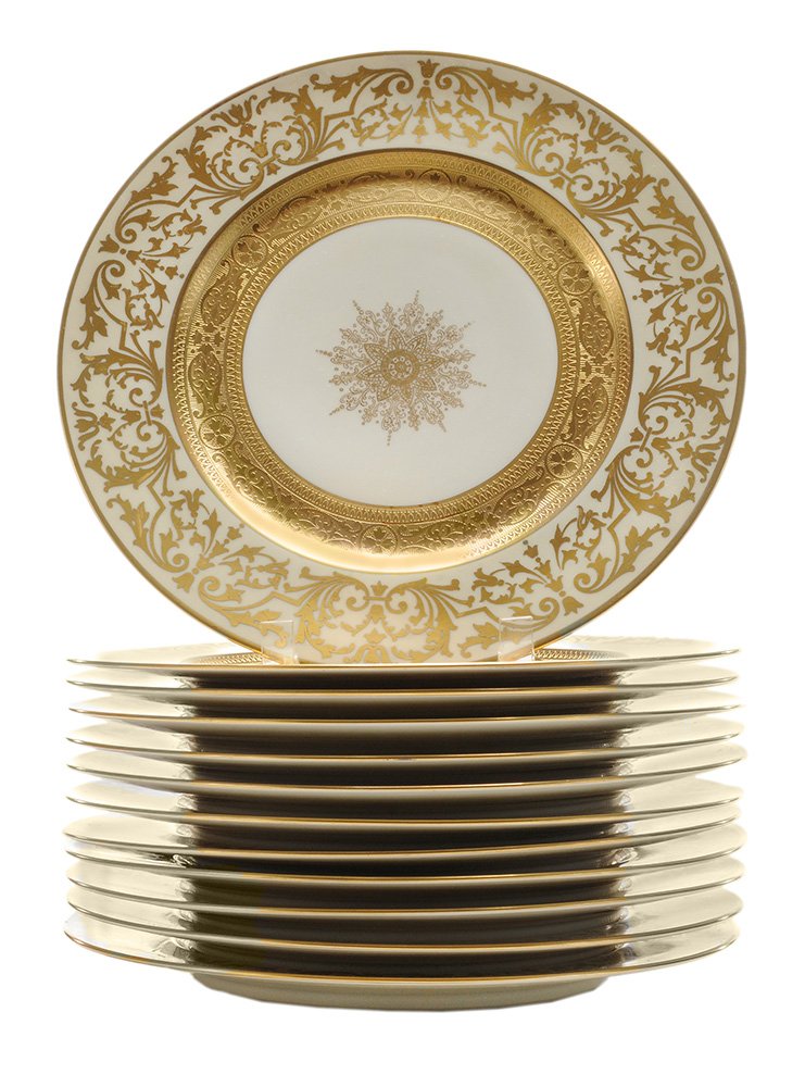 Set of Twelve Bavarian Service Plates: Germany, 20th century, starburst centers with heavily gilt band at center edge, surrounded by tulip and stylized vine borders with gilt rims, ivory ground, marked "H & G Selb Bavaria Heinrich & Co WAR