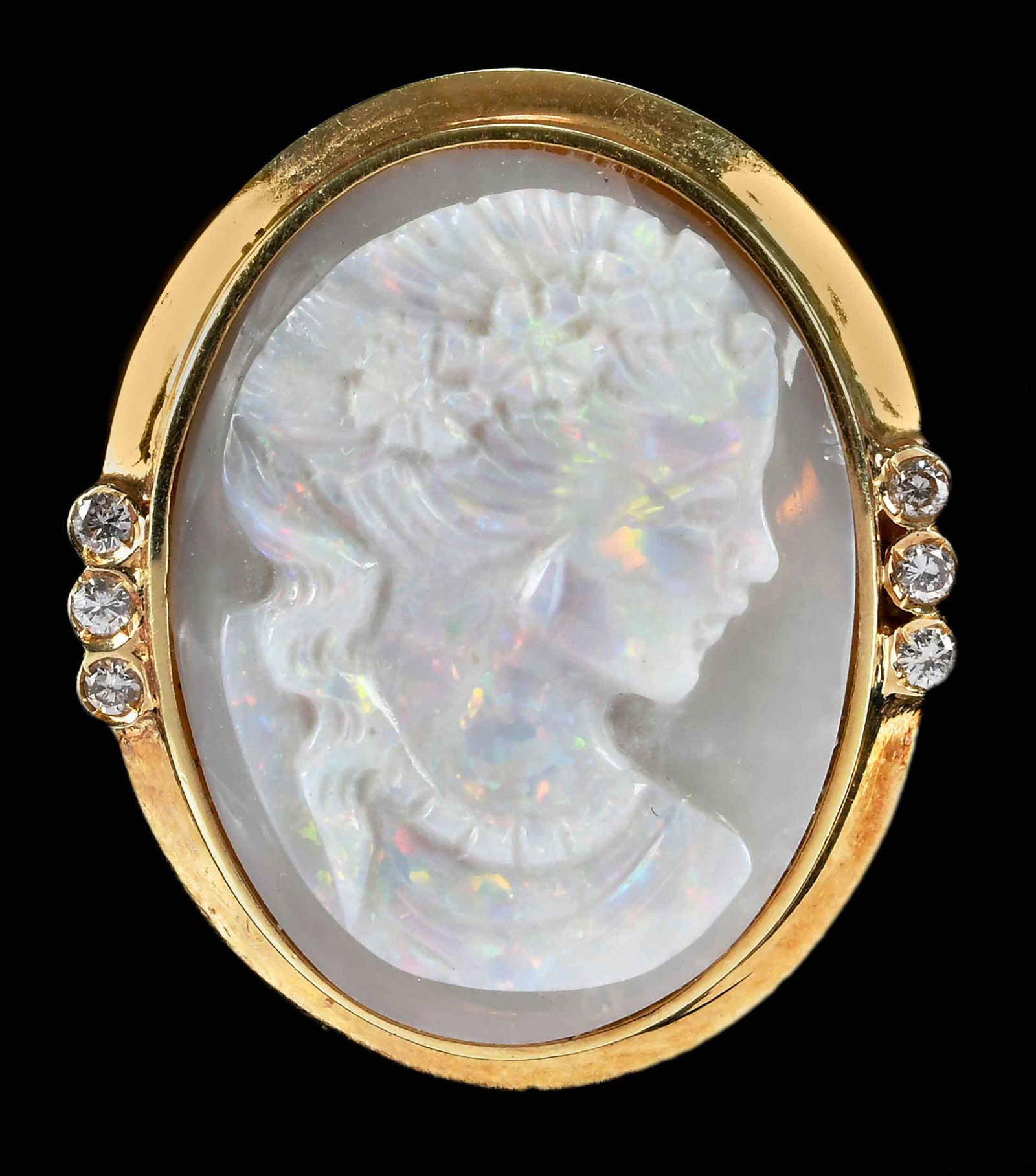 14kt. Opal Cameo and Diamond Ring: oval carved cameo opal, approx. 22.0 x 17.0mm, six round full cut diamonds, marked "585 14K", yellow gold, 6-3/4 ring sz., 7.7 g Provenance: Private Collection Note: Brunk Auctions makes no warranty o