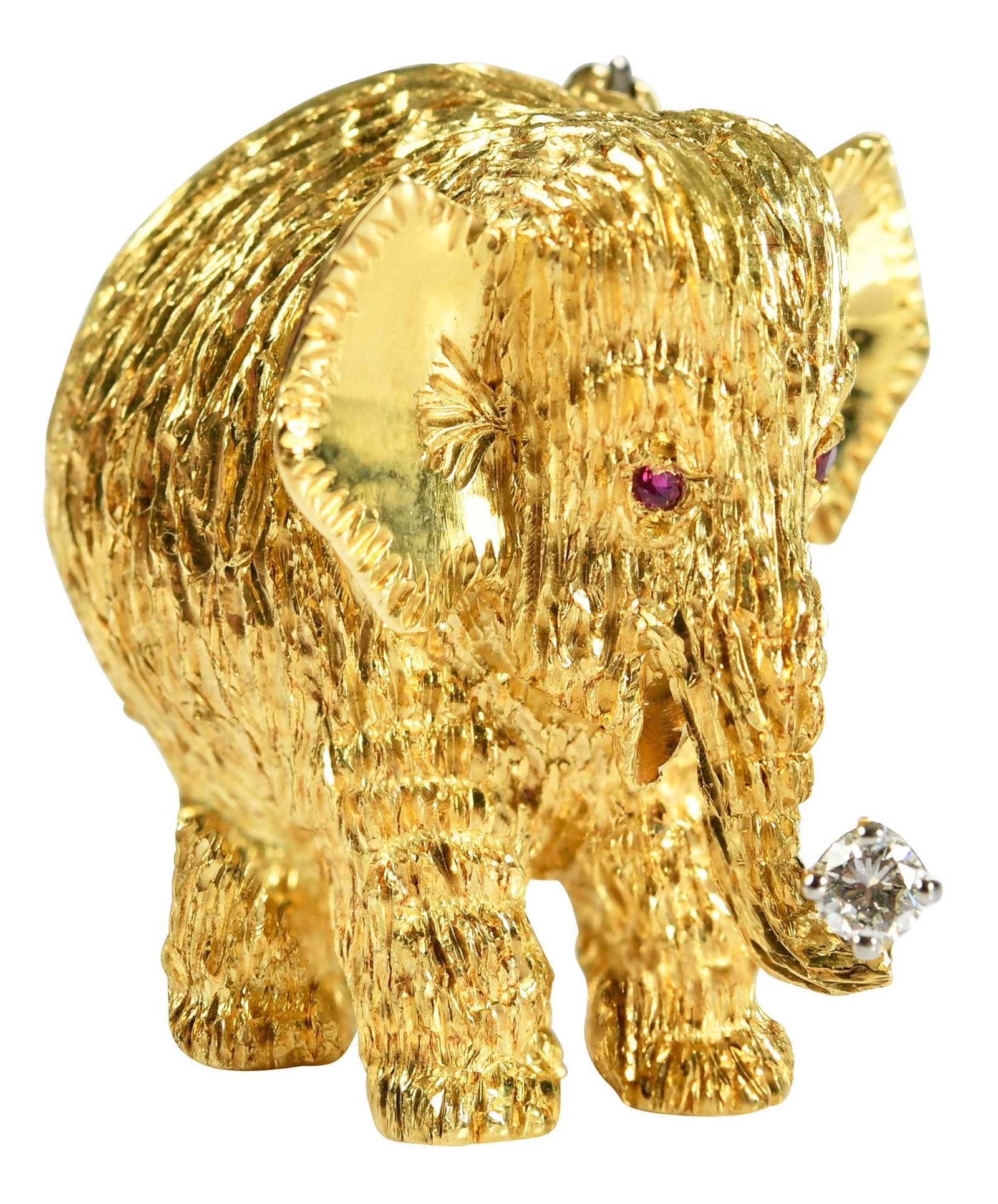 18kt. Elephant with Diamond Brooch: one round faceted full cut diamond, two round full cut ruby eyes, textured finish, marked "18K, PD", yellow gold, 1 in. length, 10.9 g, accompanied by Pampillonia box Provenance: Private Virginia Coll