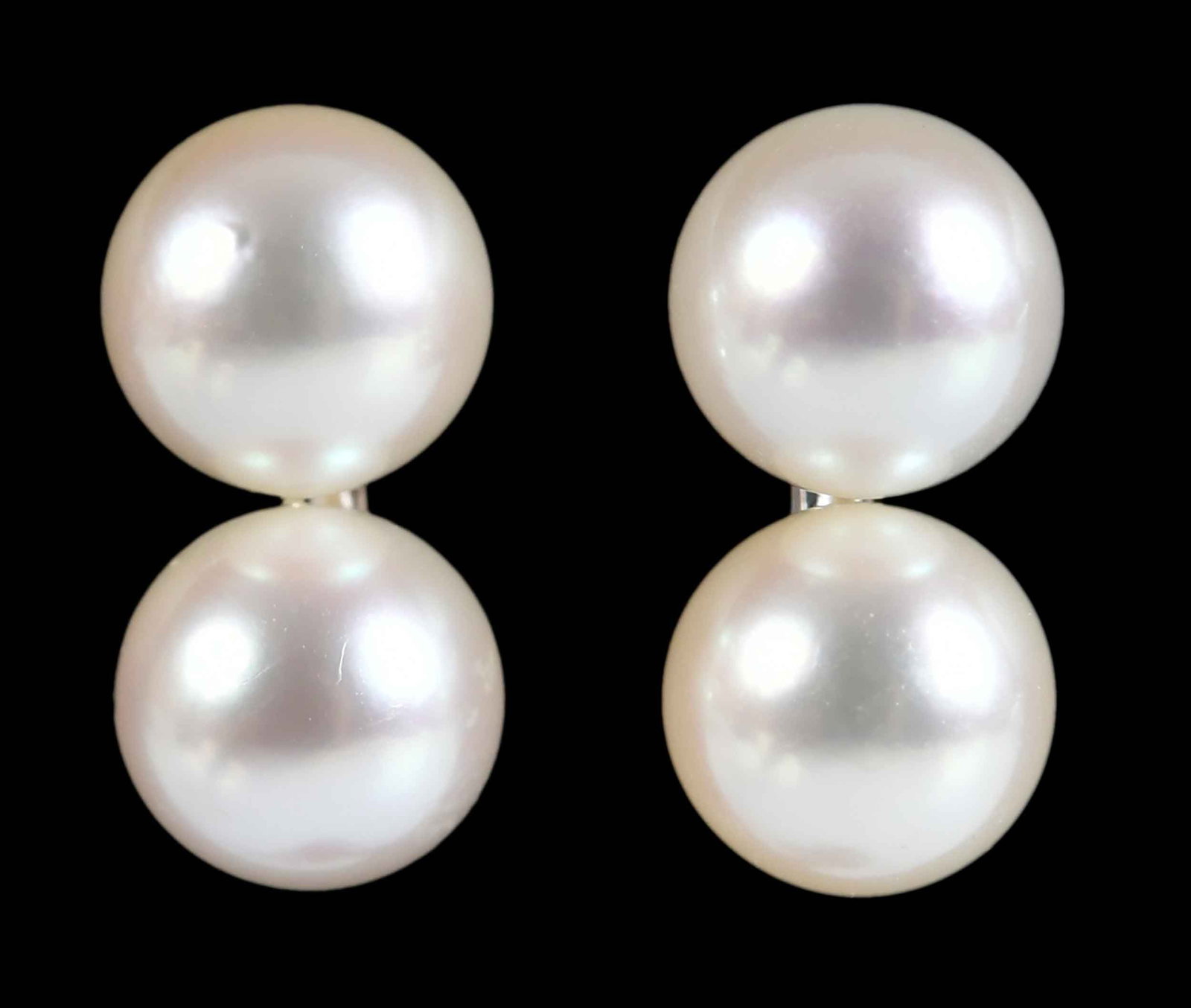 Mikimoto Double Pearl Earrings: four round white pearls, 6.5mm, marked "M", Mikimoto, screw backs, 14.0mm length, 2.9 g Provenance: Private Virginia Collection Note: Brunk Auctions makes no warranty or guarantee regarding any metal 