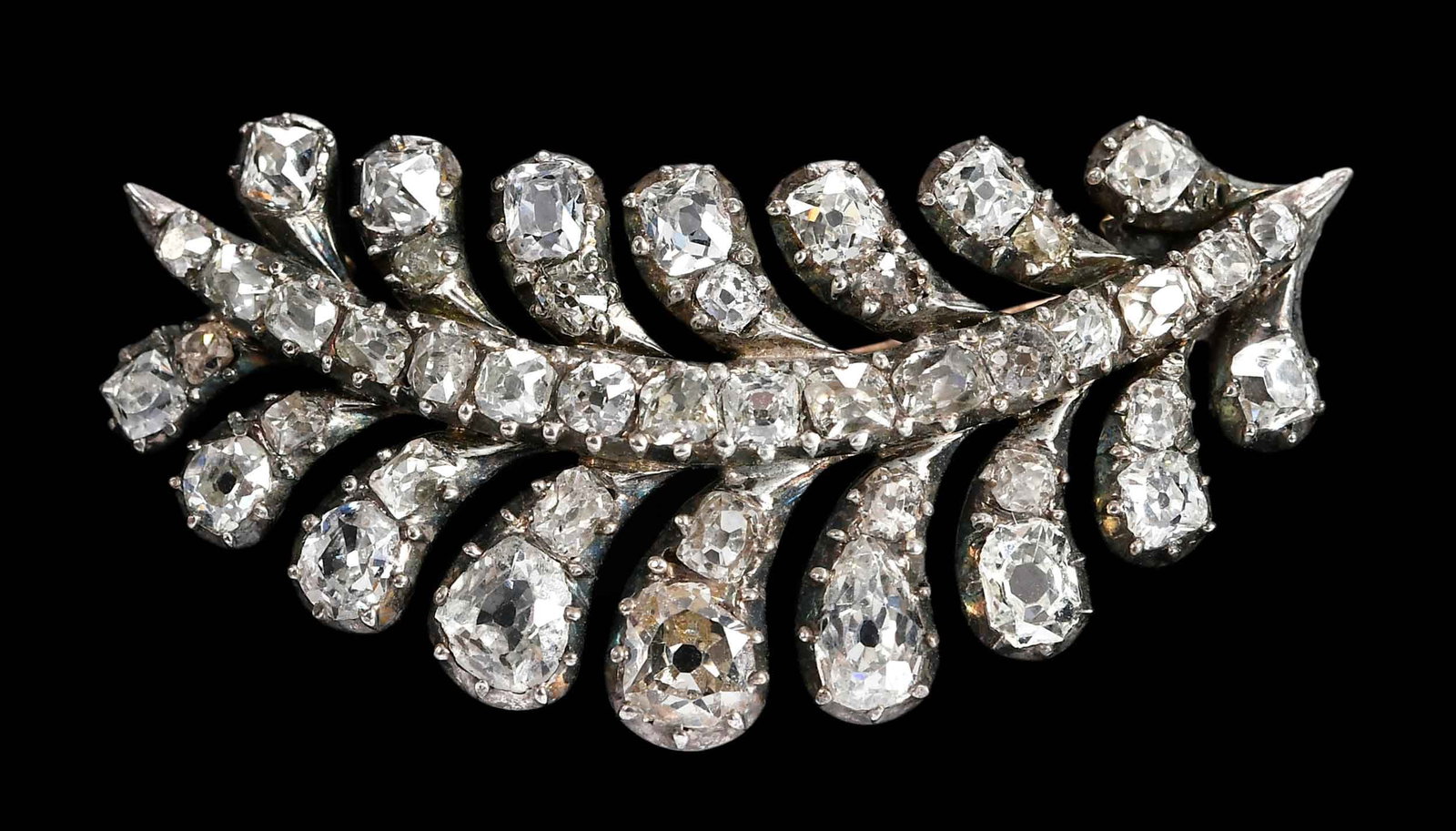 Georgian Diamond Leaf Brooch in Leather Case: old cut diamonds, ranging in sizes, tests gold paired with silver topped settings, 1-1/2 in. length, custom case "Harvey & Gore ", 7.0 g Provenance: Private Virginia Collection Note: Brunk Auctions ma