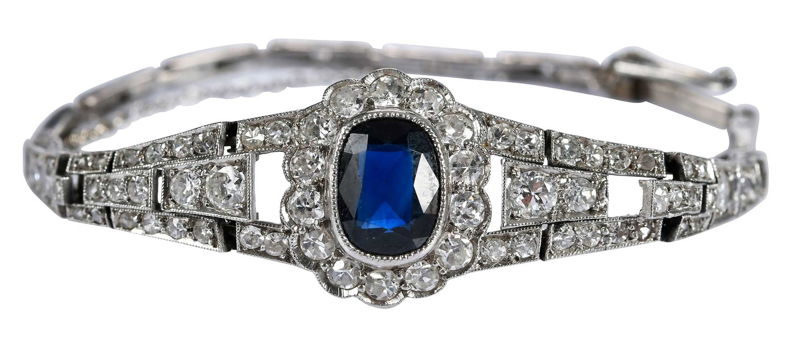 18kt. Blue Sapphire and Diamond Art Deco Bracelet: elongated oval faceted cut blue sapphire, approx. 8.0 x 6.0mm, full and single old cut diamonds, tests18kt. white gold, 7 in. length, 14.0mm wide, safety chain,11.5 g Provenance: Shippen Family Note: 