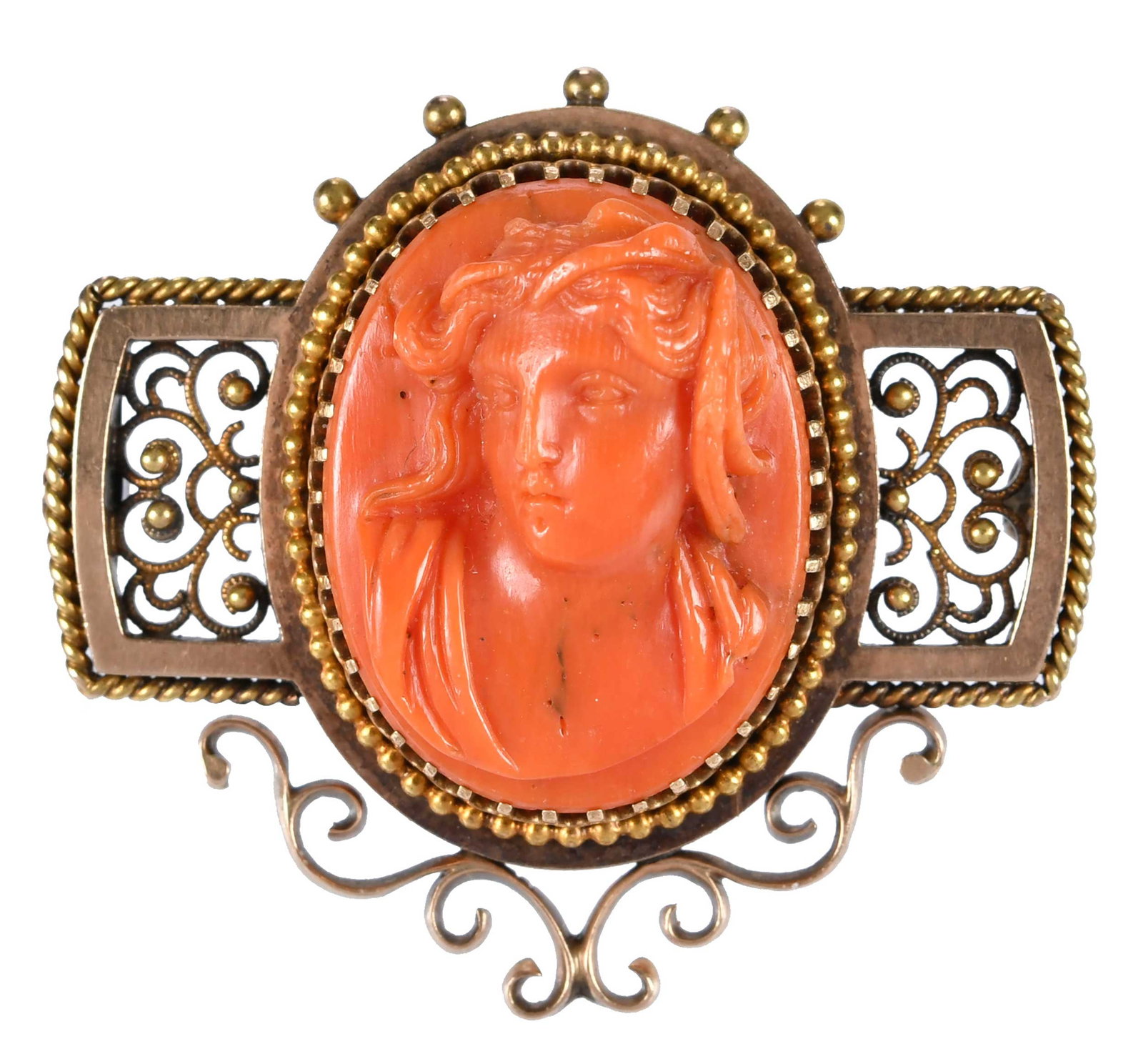 14kt. Victorian Coral Filigree Cameo Brooch: carved coral, tests 14kt. yellow gold, 1-5/8 x 1-1/2 in., 12.1 g Provenance: Charlottesville, Virginia Collection Note: This piece contains natural coral subject to strict state, federal, and internat