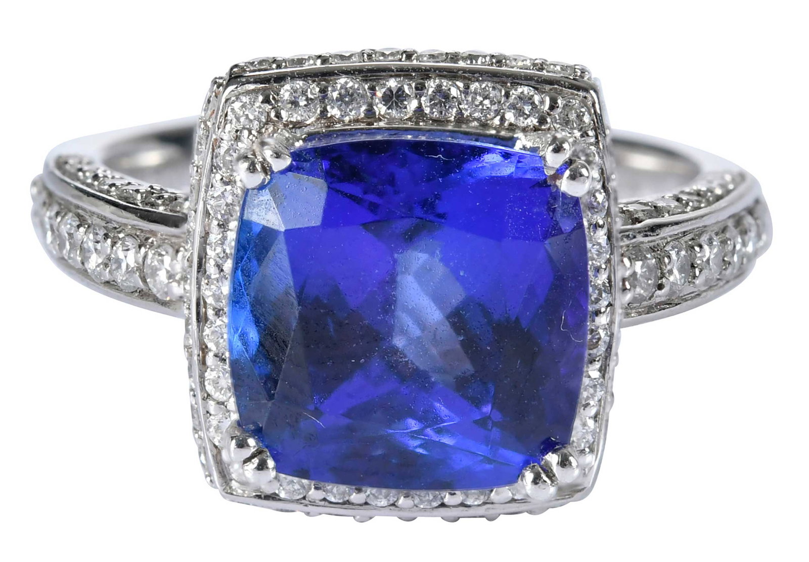 Platinum Tanzanite and Square Diamond Halo Ring: cushion cut tanzanite, approx. 4.25ct., round faceted diamonds, marked "PT950STS, Rhapsody", white gold, 6-3/4 ring sz., 9.8 g Provenance: Private Collection, Virginia Beach Note: Brunk Auctions makes