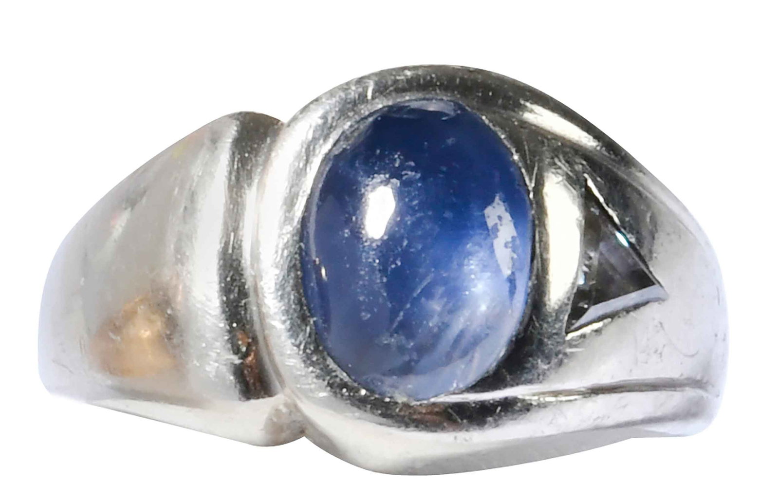 14kt. Blue Star Sapphire and Diamond Ring: oval cabochon blue star sapphire, approx. 4.50ct., one triangular step cut diamond, marked "14K", white gold, 8-1/4 ring sz., 10.8 g Provenance: Private Collection Note: Accompanied by an appraisal re
