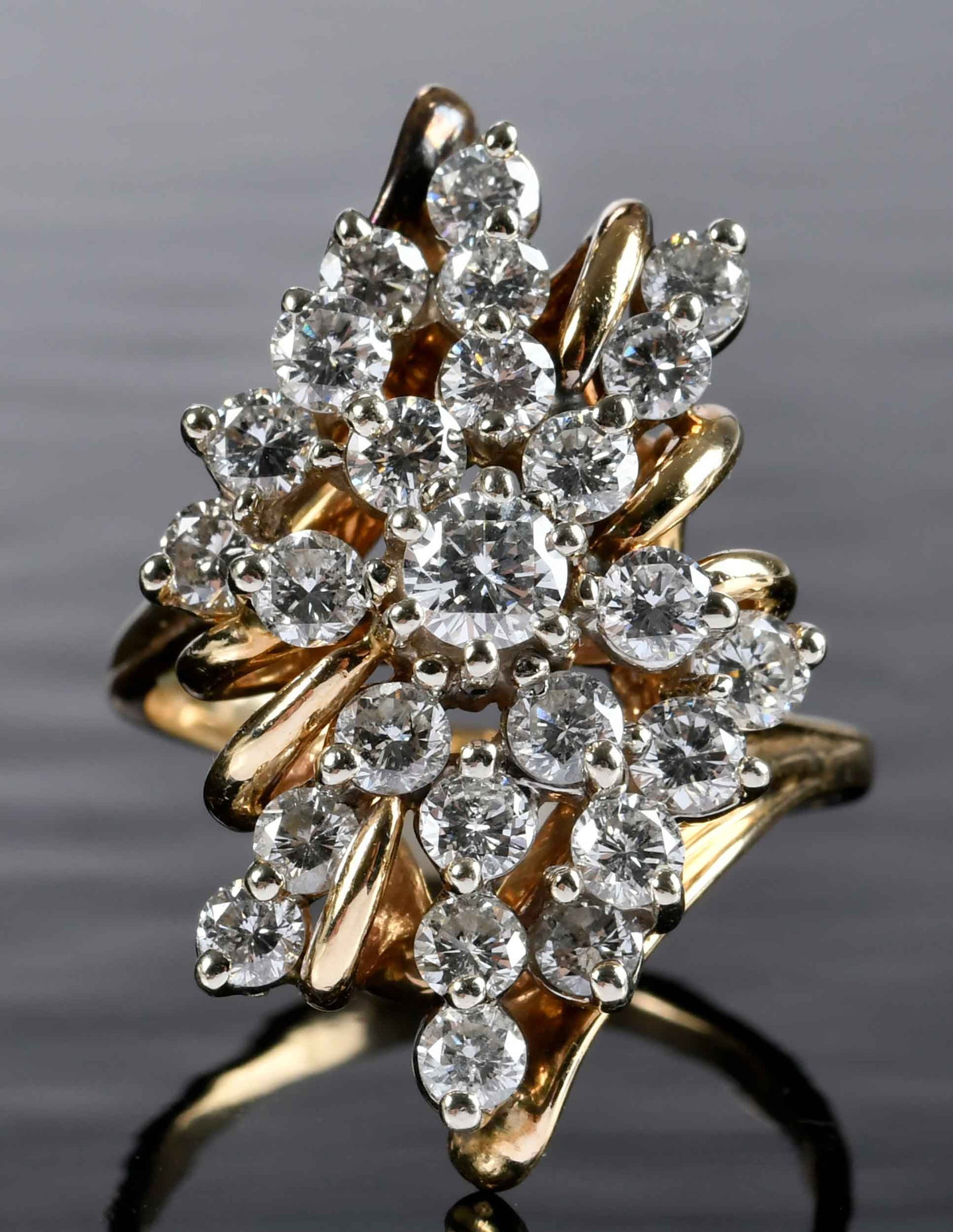 14kt. Diamond Waterfall Cluster Ring: central round faceted diamond, approx. 0.25ct., 24 round faceted diamonds, approx. 2.50ctw., SI, G-I, marked "14K, Exquisite", yellow gold and white gold,10 ring sz.,11.1 g Provenance: Private Collect