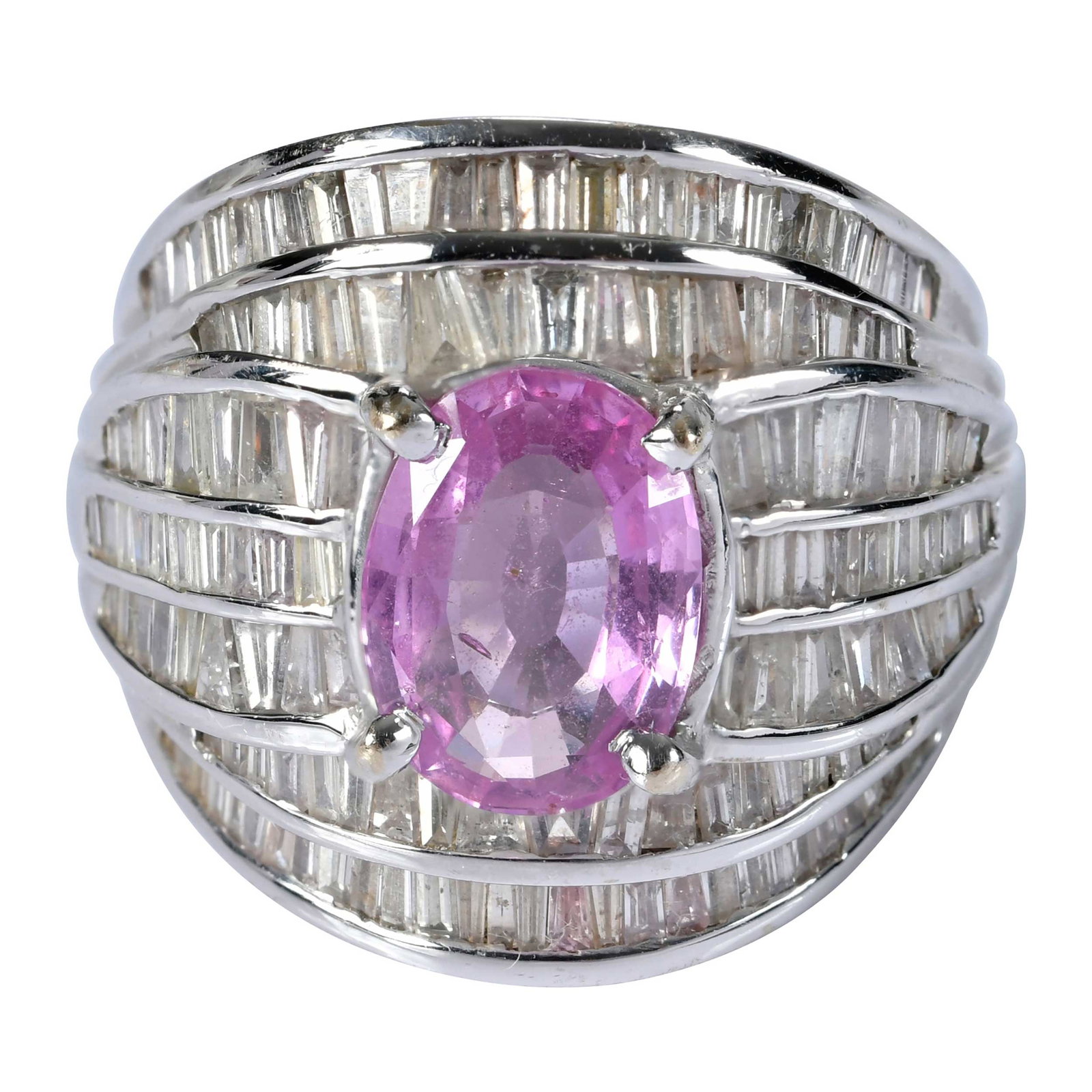14kt. Pink Sapphire and Baguette Cut Diamond Ring: oval faceted pink sapphire, approx. 2.20ct., 7 rows of channel set baguette diamonds, approx. 2.25ctw., tests 18kt. white gold, 8 ring sz., 11.4 g Provenance: Private Collection, Virginia Beach Note: 