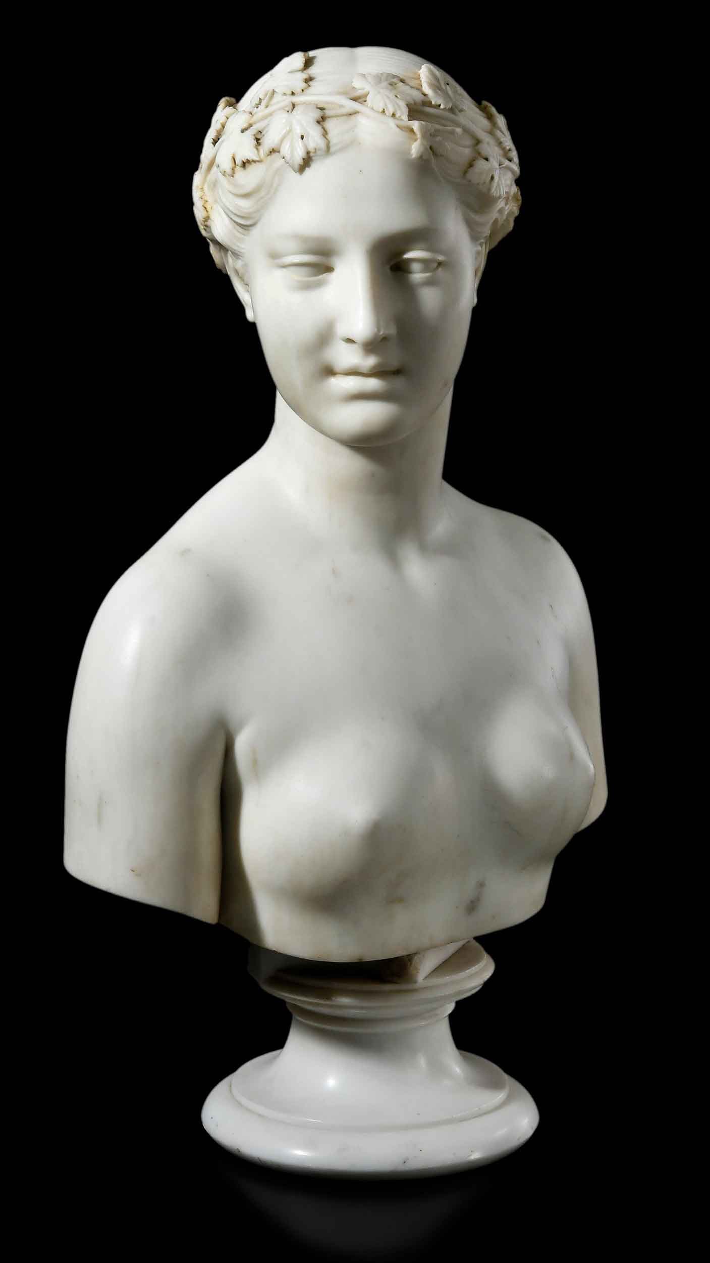 A Rare Signed Alexander Galt Sculptural Bust: (Virginia, 1827-1863) A Bacchante, wearing a grapevine wreath, circa 1860, marble, signed with conjoined last name "GALT", carved marble, 23-3/4 x 16-1/2 x 8-3/4 in. Note: Alexander Galt