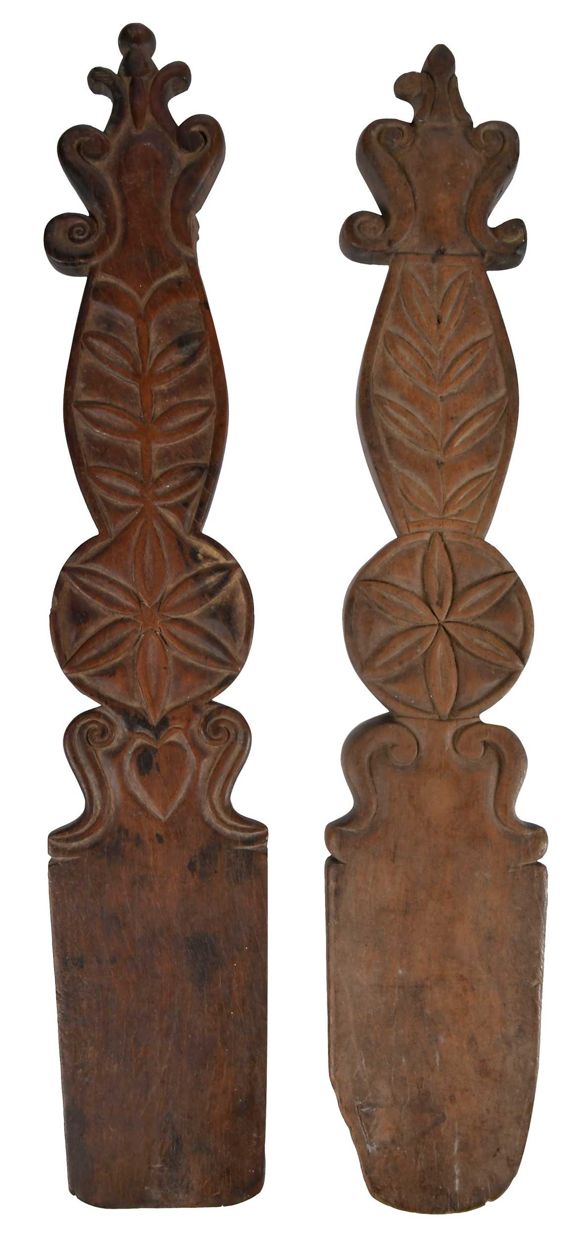 Near Pair of Pennsylvania Dutch Carved Wood Bed Smoothers: 19th century, both with carved tulip motifs, one with heart, larger 17-3/8 x 3-1/4 x 3/4 in. Provenance: Collection of Dr. James Harkrader, Richmond, Virginia