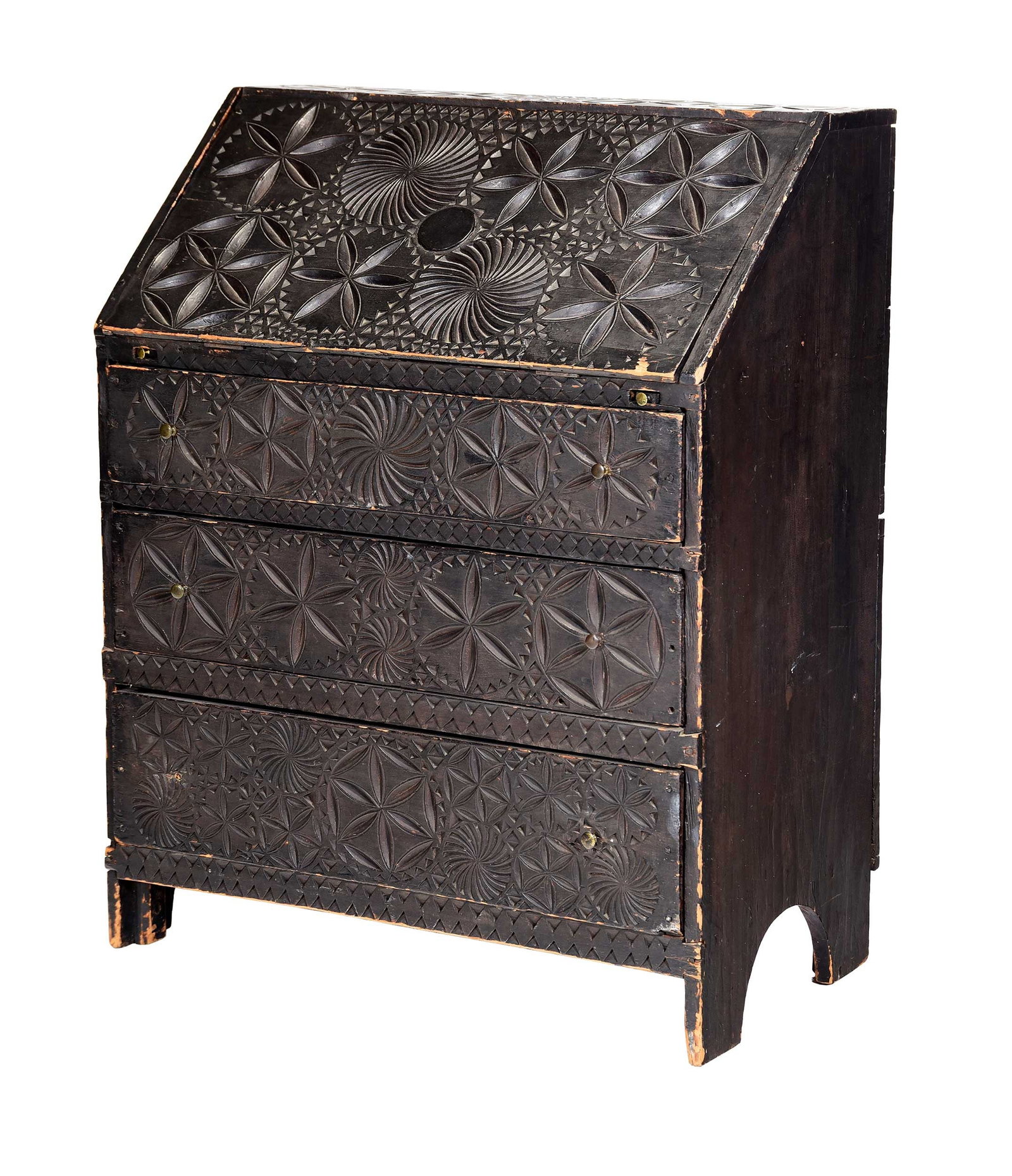 American Folk Art Carved and Painted Slant Front Desk: 19th century, probably original black paint, exterior with geometric relief carving featuring hexafoils and whirling rosettes, sawtooth carved interior with three pigeon holes, pine throughout,