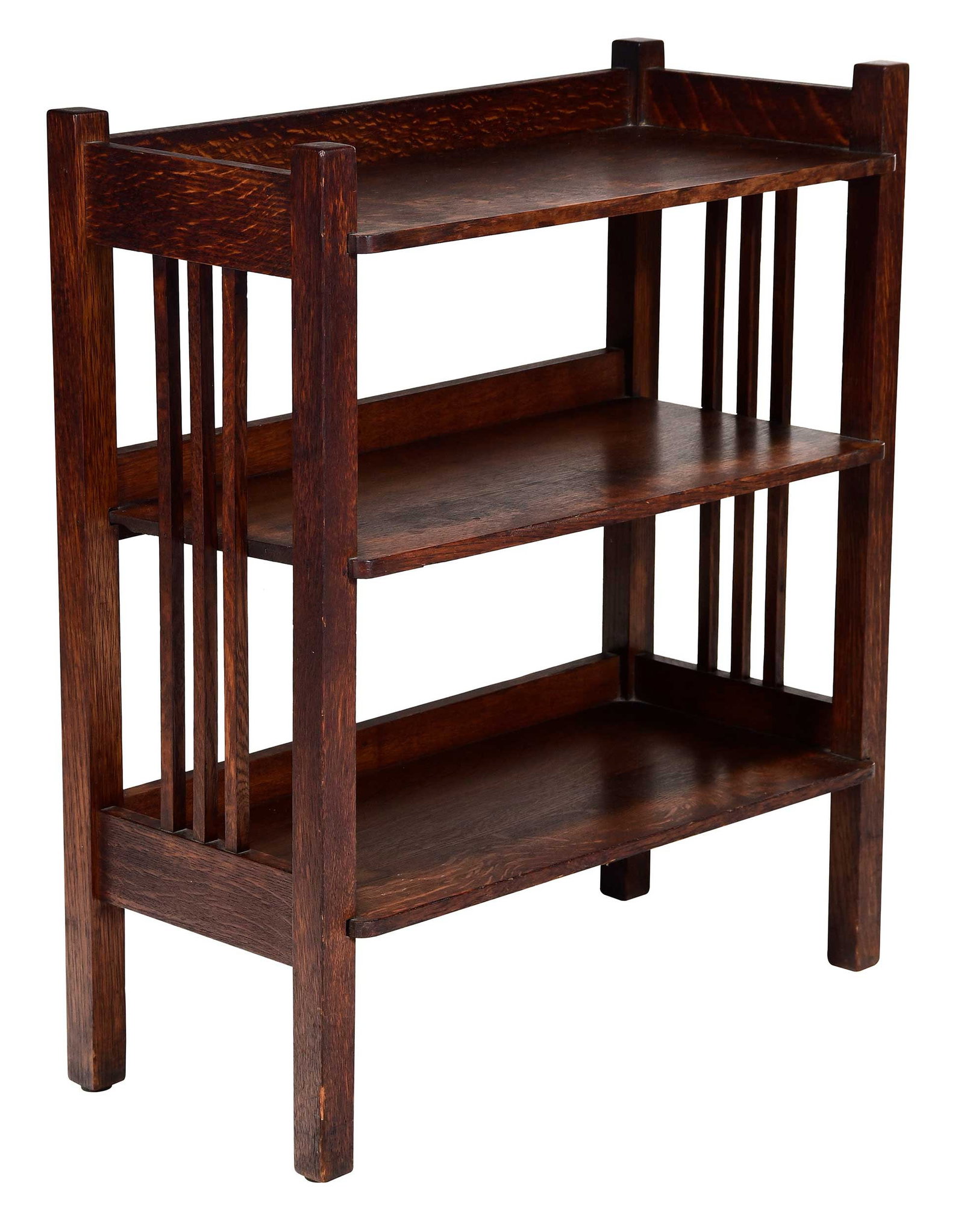 Stickley Brothers Arts and Crafts Oak Magazine Stand: early 20th century, metal badge to underside reads "QUAINT FURNITURE / STICKLEY BROS. CO. / GRAND RAPIDS MICH." and stamped "358-702", three shelves, 31 x 26-1/2 x 12-1/2 in. Provenance: Private