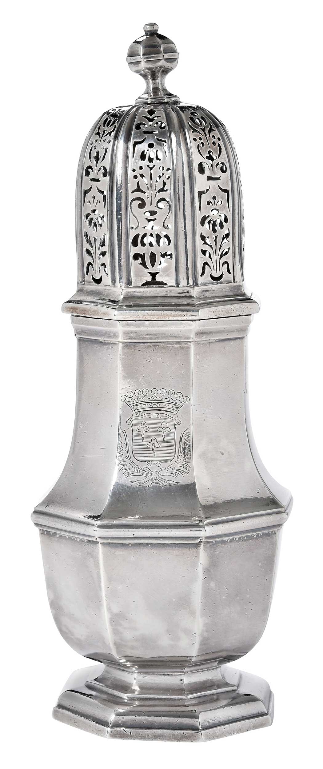 William III English Silver Caster, John Chartier: London, 1700, octagonal and on conforming foot, the detachable covers with urn finial, pierced top, engraved with crest, marks for John (Jean) Chartier, Britain standard, 18.01 oz. T., 8-3/4 in.