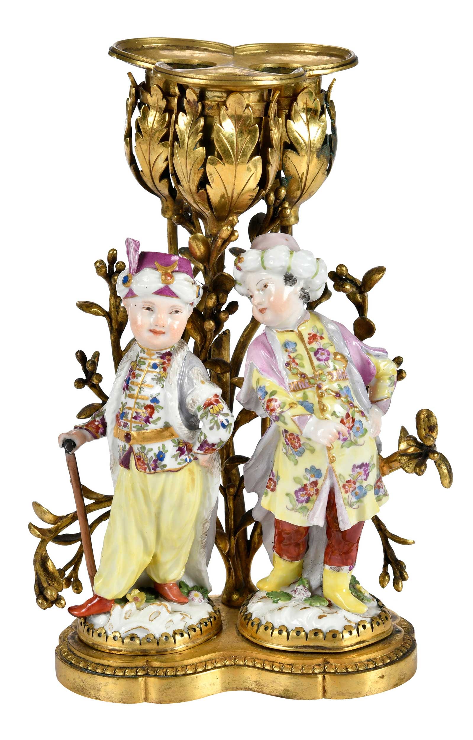 Brass Three Light Bar Candelabra with Two Meissen Porcelain Figures: German, 19th Century, two porcelain Turkenkind figures, presumably marked with crossed swords with the number "2520" and "2983", mounted to foliate decorated candelabra with three candle cups 8 x
