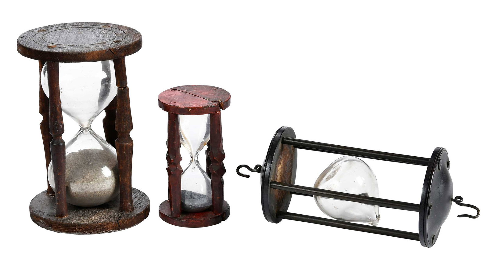 Three Early Hourglasses: possibly late 18th/early 19th century, varying woods, finishes, and sand, hanging example frame only and does not function, possibly made for use on a ship, largest 9-3/4 x 3-3/4 x 3-3/4 in. Provenanc