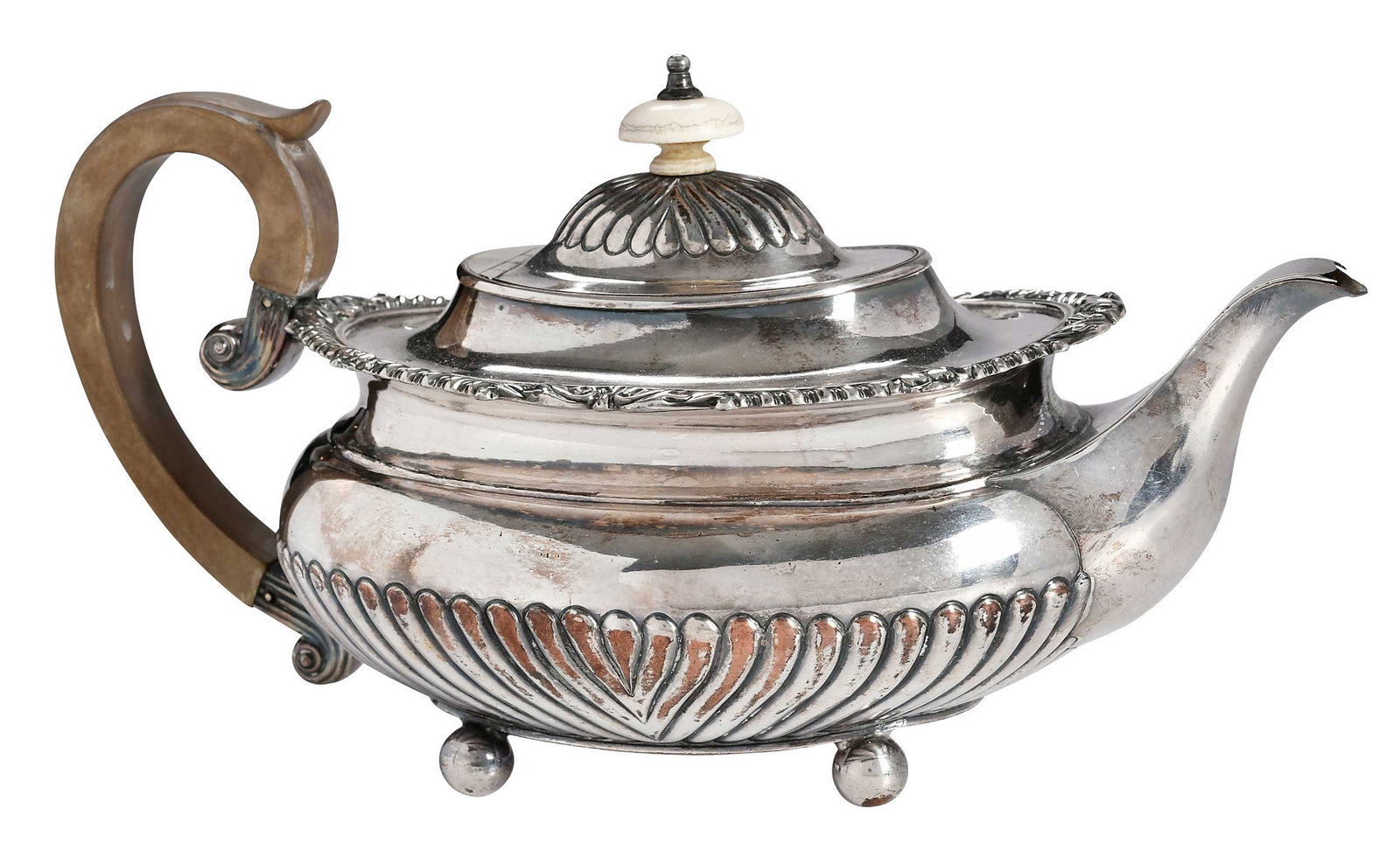 Old Sheffield Plate Teapot, Matthew Boulton: English, late 18th/early 19th century, oval form, gadroon borders, ball feet, ivory finial, wooden handle, sunburst marks for Matthew Boulton, 5-1/2 x 11 x 5-1/4 in. Provenance: Lifetime Collection