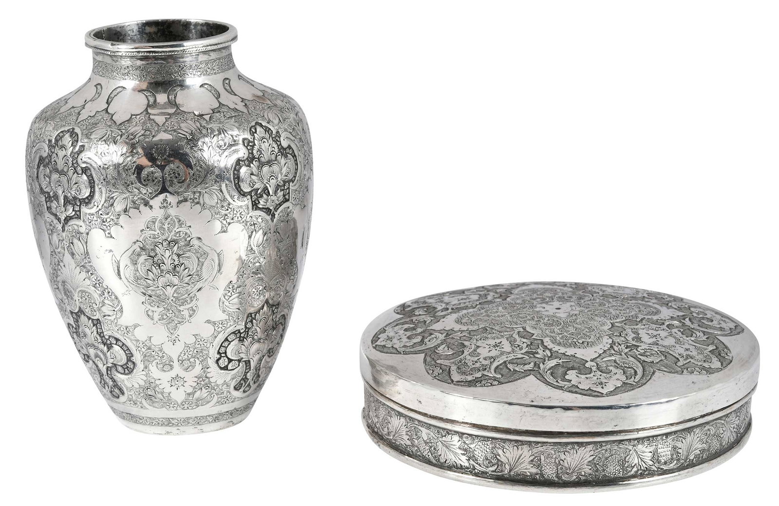 Two Pieces Persian Silver Table Items: 20th century, both with arabesque decoration, including round vase, marked on base "84", 5-1/4 in.; round box, marks on base, 1-1/2 x 5 in., 18.13 oz. T. total weight Provenance: Private Collection