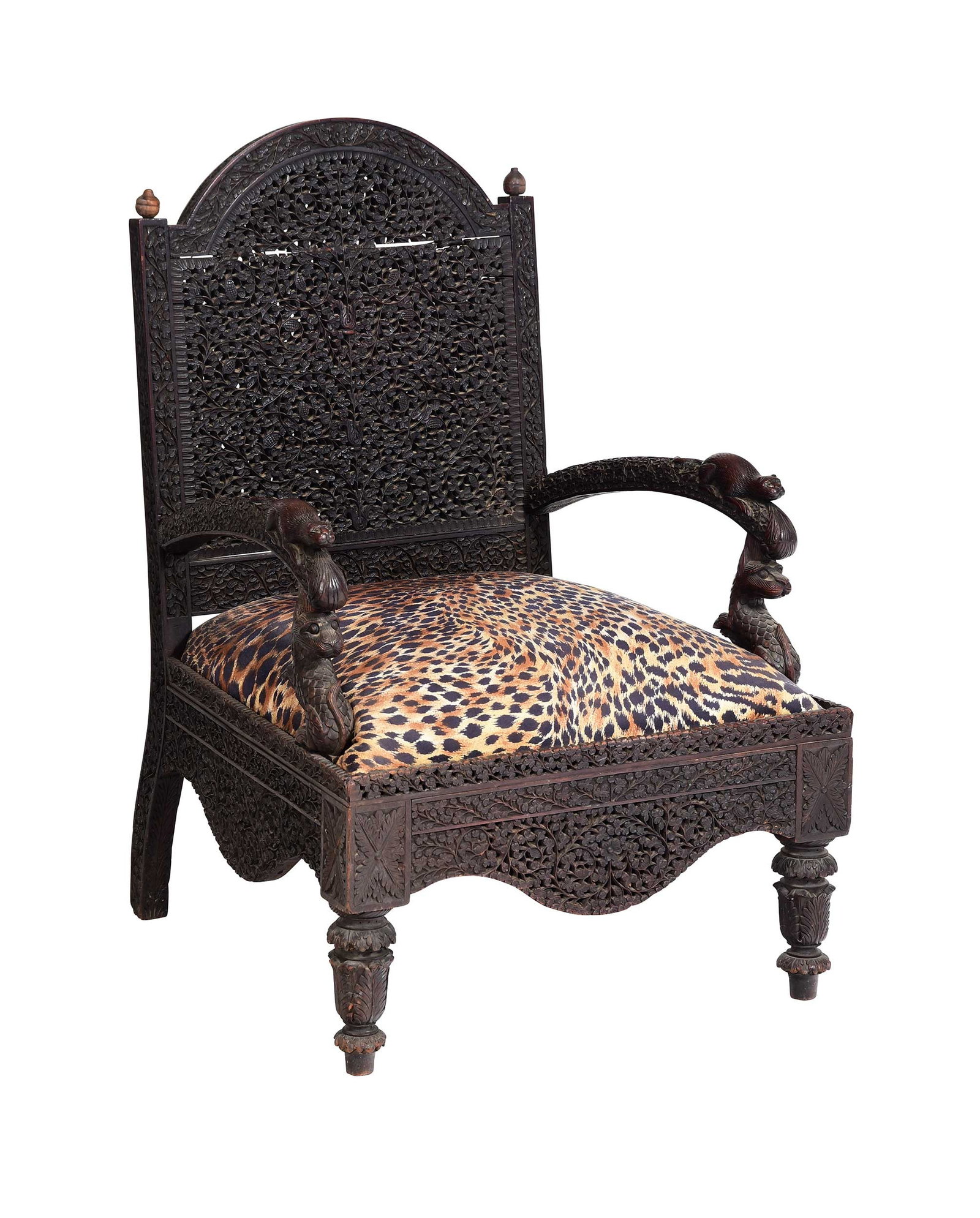 Anglo Indian Carved and Pierced Armchair, Figural Carvings: probably 19th century, arched open work and relief carved back, arms terminating in rats on dog supports, foliate carved feet, leopard pattern seat and loose cushion, 37 x 25-1/4 x 26 in., seat