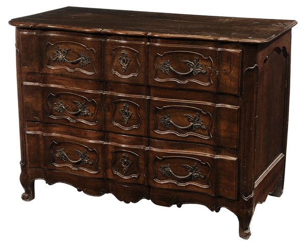 Provincial Louis XV Walnut: Serpentine-Front Three-Drawer Commode French, 18th century, overhung thumb-molded top over three drawers with carved fronts and applied baroque floral handles, carved and scalloped apron, scrolled fee