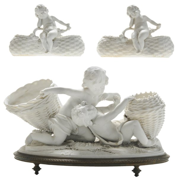 Three Pieces Biscuit Porcelain: French, 19th century: large figure of two frolicking [putti,] each holding baskets serving as vases, on oval naturalistic mound, signed "André", otherwise unmarked, on finely cast bronze oval base, 7