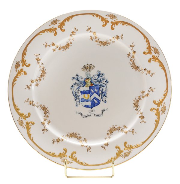 Minton Semans-Duke Family Plate: English, late 20th century, white porcelain plate with Seman-Duke family crest in center, gilt floral and scroll decoration, marks for Minton, excellent condition. Provenance: Les Terrasses