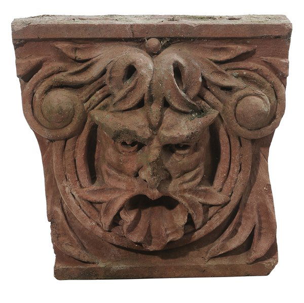 Terra Cotta Mask Plaque: 20th century, central mask with scroll decoration, 15-1/4 x 16-1/4 x 4-1/4 in. loss to nose and eye brow, some discoloration, chips. Provenance: Les Terrasses