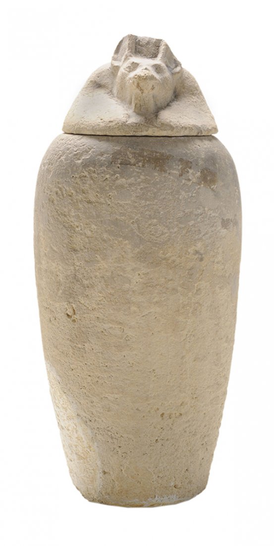 Ancient Egyptian Carved Limestone: Canopic Funerary Jar probably between 18th and 19th dynasties, the lid depicting the head of Anubis (god of death) with tapered cylindrical jar, 12 in., surface wear and losses overall, Anubis head wi