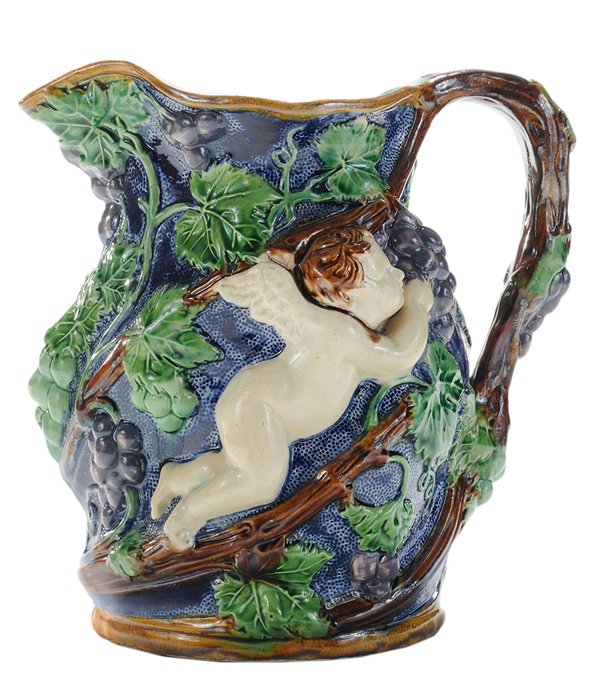 Minton Majolica [Putti] and Grape Jug: England, late 19th century, stippled cobalt blue ground jug, modeled with [putti] eating white and purple grapes, grape vine figured handle extending to rim and base, turquoise ground interior and bot