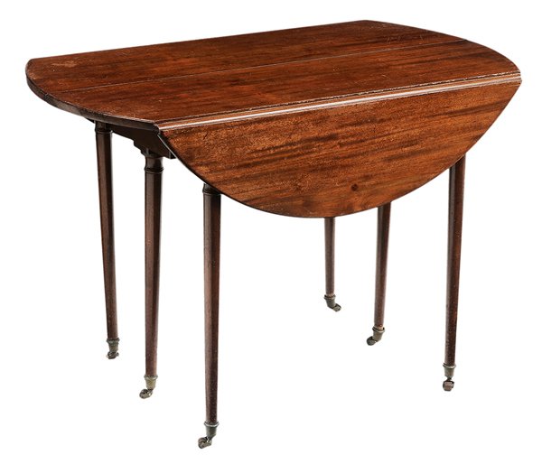 [Directoire] Style Mahogany Oval: Drop-Leaf Extension Table British or French, late 19th century, figured mahogany with turned legs and brass casters, 28 x 23-1/2 x 40-1/2 in., opens to 84-1/2 in., surface distress and finish losses o