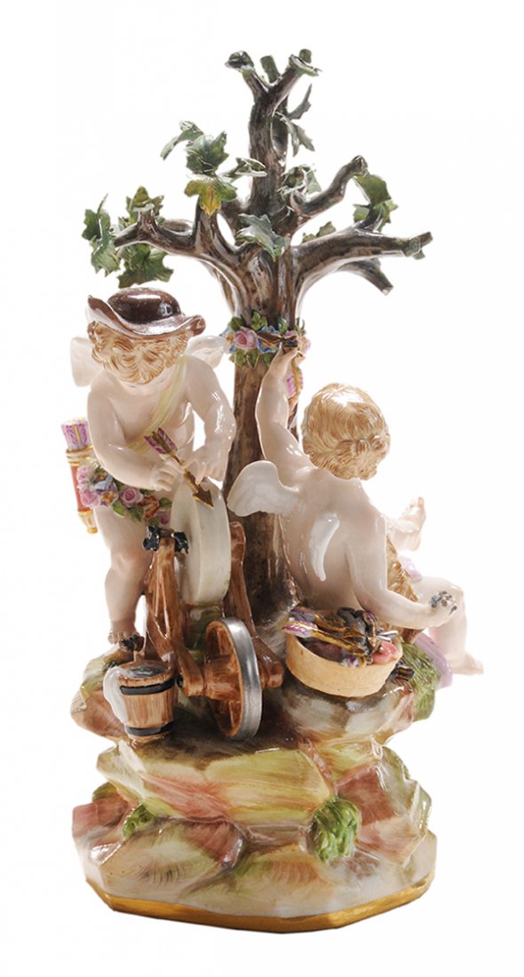 Meissen Porcelain Figural Group: Depicting Cupid Sharpening His Arrows German, probably 19th century, Cupid and frolicking female figure, inscribed mark "E26" and blue crossed swords mark in blue underglaze, 7 in., extensive losses t