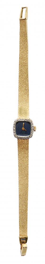 Lady's Gold and Diamond Bulova: Watch 14 kt. yellow gold Bulova watch with dark blue enameled square face, mechanical movement, serial number 1125004, 14 kt. yellow gold stone-finish strap with double fold-over clasp, 24 round singl