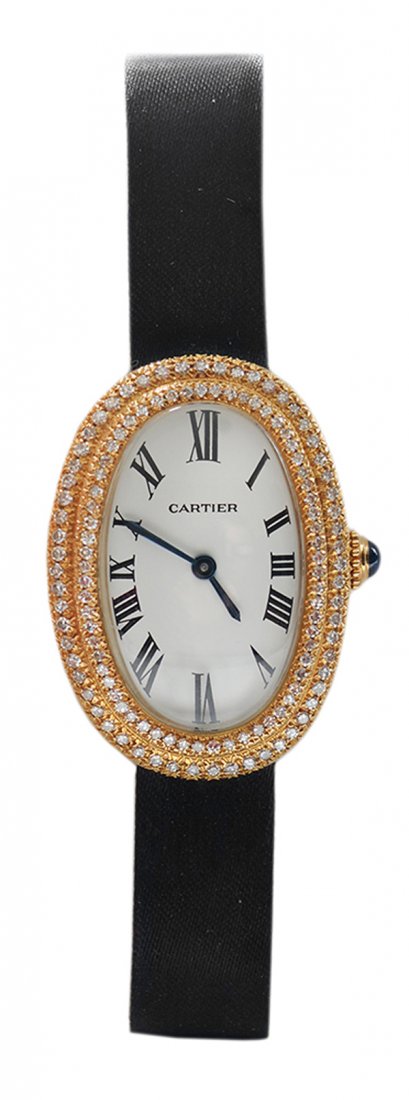 Lady's Luxury Cartier Diamond Watch: 18 kt. yellow gold with oval face and quartz movement, Roman numeral hour markings, black hands, black satin band with deployment clasp, back of case and face marked "Cartier" and "780944436", 121 rou
