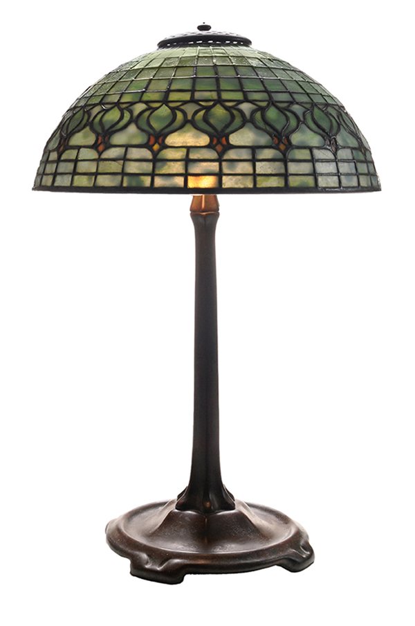 Tiffany Studios Leaded Stained Glass: and Patinated Bronze Table Lamp American, early 20th century, leaded glass shade in shades of green and amber, stamped "Tiffany Studios New York #1561", on three-light patinated bronze stand stamped "