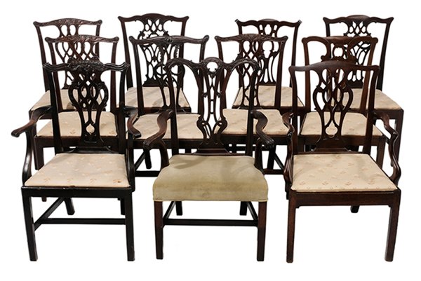 Assembled Set of Eleven Chippendale: Mahogany Dining Chairs British, 18th century, comprising an armchair with finely carved back, scrolled arms and green velvet over-the-rail upholstery, [legs spliced, patches at rear stiles with later 