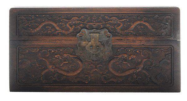 Finely Carved Camphorwood: Covered Storage Box Chinese, probably early 20th century, hinged rectangular top carved with flying dragons and phoenixes in a treed landscape with stylized clouds, geometric devices at corners, front