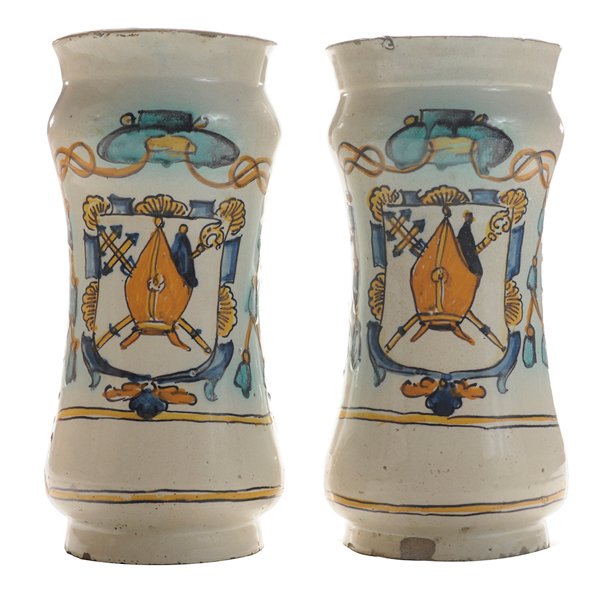 Pair Spanish Polychromed and Tin-: Glazed Earthenware Albarelli probably Valencia, late 17th century, depicting a coat of arms with cartouche below, white ground with design in blue, green, manganese and yellow, 9-1/4 in., each with on