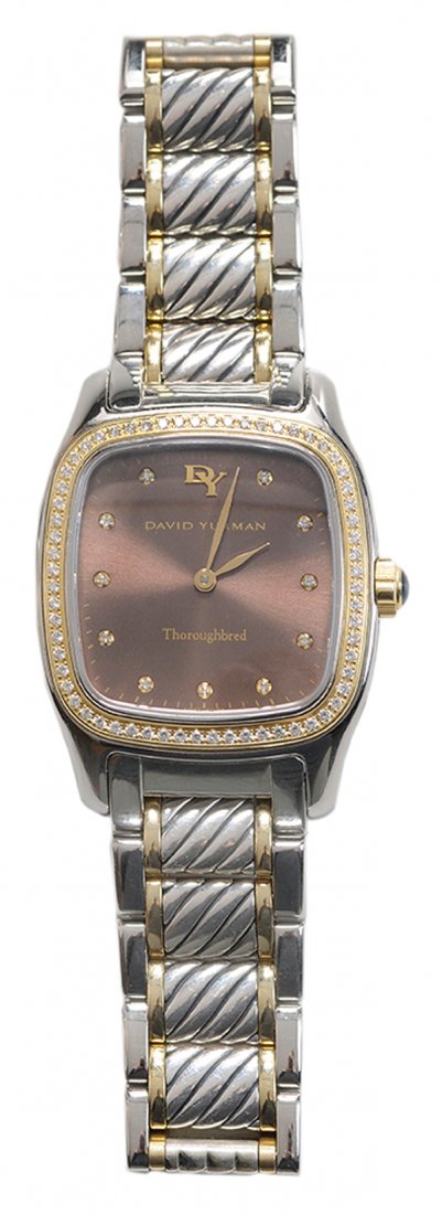Man's David Yurman Watch: "Thoroughbred" stainless steel and 18 kt. gold accents, diamond markers and bezel set diamonds around dial, estimated diamond weight 0.56 cts., blue spinal cabochon crown, scratch resistant sapphire c
