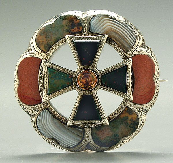 Scottish agate brooch,: elaborately engraved sterling silver mount, six outer lobes set with fitted agate and jasper cabochons, central Celtic cross with bloodstones and faceted cairngorm (Scottish citrine), engraving verso,