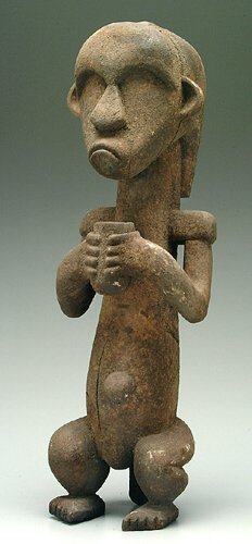 Carved African figure holding vessel