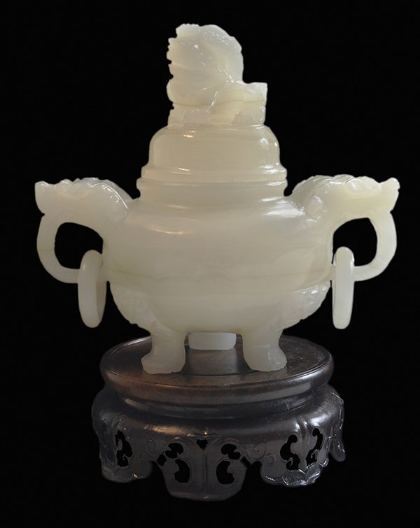 Xin-Jiang White Jade Incense Burner: Chinese, 20th century, the burner with foo dog cover, circular body with carved foo dog and loose-ring handles, flaring animal paw tripod feet, 5-3/4 x 5-3/4 x 3-3/4 in., finely carved circular zitan 