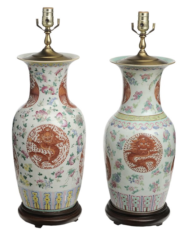 Two [Famille Rose] Enameled Jars: Chinese, late 19th/early 20th century: one with rose and yellow floral design on white ground and brick-red medallions with Buddhist dragon symbols, wood base, 19-3/4 in. to top rim, [drilled and conv