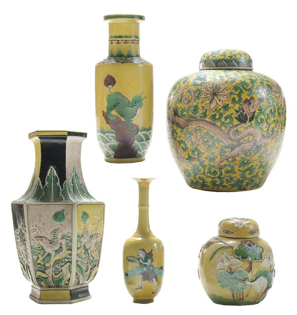Three Yellow-Ground Enameled: Porcelain Vases, Two Ceramic Covered Jars Chinese: one vase with overhung rim and banded neck, body with foo lions and dragons in a landscape, unglazed foot, base with impressed six-character mark wit